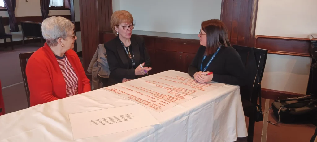 Three participants completing a discussion activity